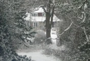 Snow-covered Abacus Bed & Breakfast as seen from walkable woods to rear